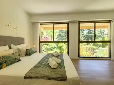 a bedroom with a large bed with two towels on it at Nestor&Jeeves - PALM RIVIERA - Central - Close Old Town in Nice