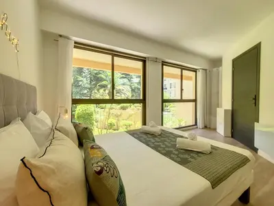 a bedroom with a large bed and a large window at Nestor&Jeeves - PALM RIVIERA - Central - Close Old Town in Nice