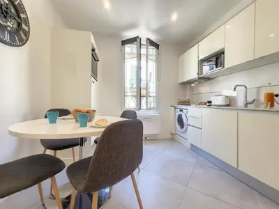 a kitchen with a table and chairs in a room at Nestor&Jeeves - L ANCRE - Port Area - Close Old Town in Nice