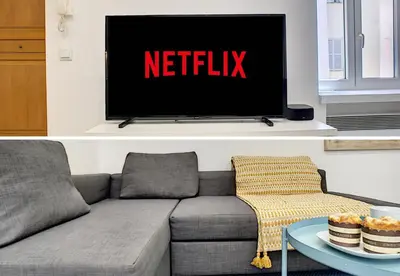 a living room with a couch and a tv with the netflix sign at Nestor&Jeeves - URBAN SUN - Central - Close sea in Nice
