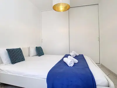 a room with a white bed with towels on it at Nestor&Jeeves - URBAN SUN - Central - Close sea in Nice