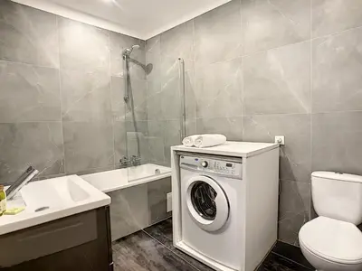 a bathroom with a washing machine and a toilet at Nestor&Jeeves - URBAN SUN - Central - Close sea in Nice
