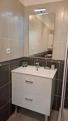a bathroom with a white sink and a mirror at Beautiful 43m2 with two double beds everything nearby in Nice