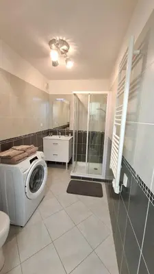 a bathroom with a washing machine and a shower at Beautiful 43m2 with two double beds everything nearby in Nice