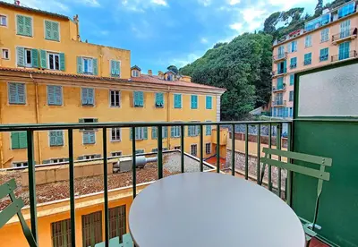 a table on a balcony with a view of buildings at Nestor&Jeeves - PORT LYMPIA - Close Old Town - Port Area in Nice