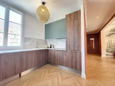 a kitchen with wooden cabinets and a large window at Nestor&Jeeves - PORT LYMPIA - Close Old Town - Port Area in Nice