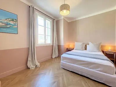 a bedroom with a large bed and a window at Nestor&Jeeves - PORT LYMPIA - Close Old Town - Port Area in Nice