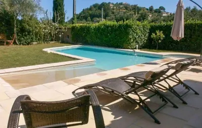 a couple of chairs sitting next to a swimming pool at Gorgeous Home In La Gaude in La Gaude