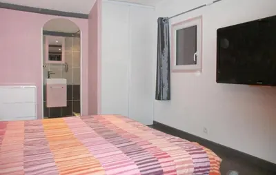 a bedroom with a bed and a flat screen tv at Gorgeous Home In La Gaude in La Gaude