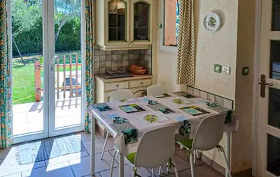 a kitchen with a table and chairs and a balcony at Gorgeous Home In La Gaude in La Gaude
