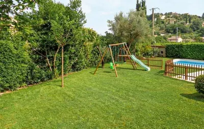 a yard with a swing set and a pool at Gorgeous Home In La Gaude in La Gaude