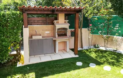 a play kitchen in a garden with a outdoor oven at Gorgeous Home In La Gaude in La Gaude