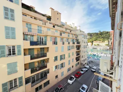an apartment building with cars parked in a parking lot at Ze Perfect Place - Chic & Cosy au Port Nice - AC in Nice