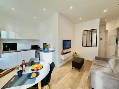 a kitchen and a living room with a table at Ze Perfect Place - Chic & Cosy au Port Nice - AC in Nice