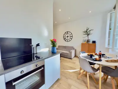 a kitchen and living room with a table and chairs at Ze Perfect Place - Chic & Cosy au Port Nice - AC in Nice