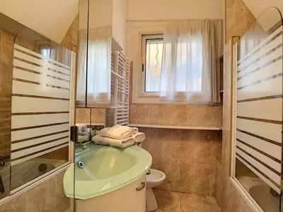 a bathroom with a tub and a toilet and a window at Nestor&Jeeves - L'OLYMPIC - Central - Very close sea in Nice
