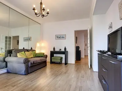 a living room with a couch and a television at Nestor&Jeeves - L'OLYMPIC - Central - Very close sea in Nice