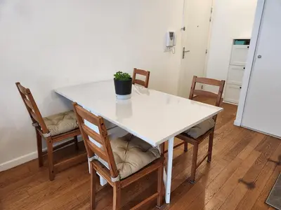 a white table with chairs and a potted plant on it at Charmant 2 pièces, centre ville & proche gare in Nice