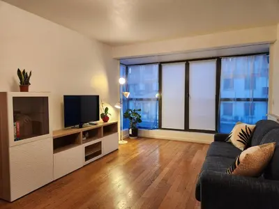 a living room with a couch and a flat screen tv at Charmant 2 pièces, centre ville & proche gare in Nice
