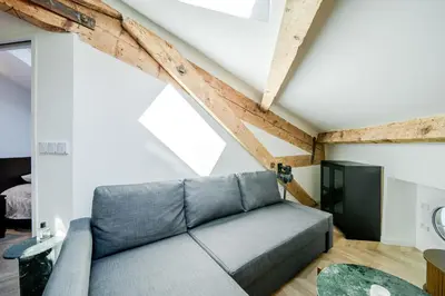 a living room with a couch in a loft at Appartement Original cœur de ville -AC- in Nice
