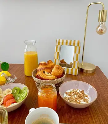 a table topped with bowls of food and orange juice at Under the Citrus Trees in Nice