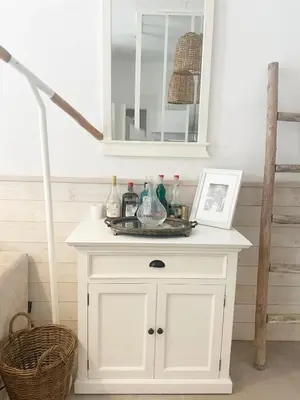 a white cabinet in a room with a mirror at Appartment with private garden in city center Nice in Nice