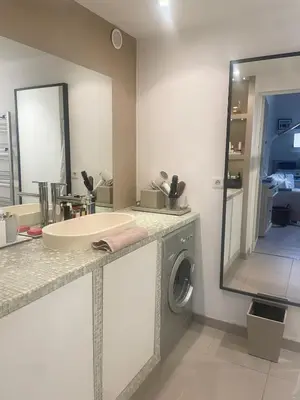 a bathroom with a sink and a washing machine at Appartment with private garden in city center Nice in Nice