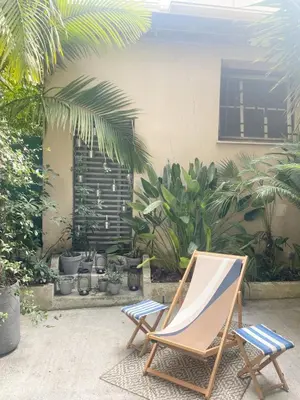 a chair sitting in a patio with plants at Appartment with private garden in city center Nice in Nice