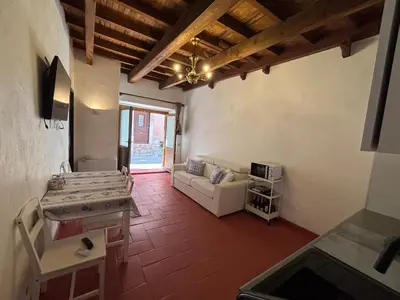 a kitchen and a living room with a couch at Morning Coffee & Cobblestones - A True French Village Stay in Villefranche-sur-Mer