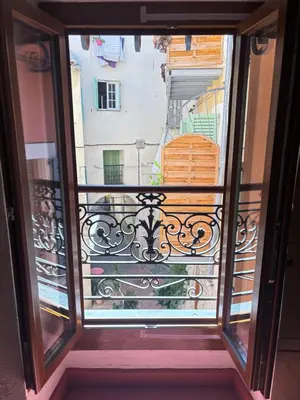 a view from the window of a balcony at Morning Coffee & Cobblestones - A True French Village Stay in Villefranche-sur-Mer
