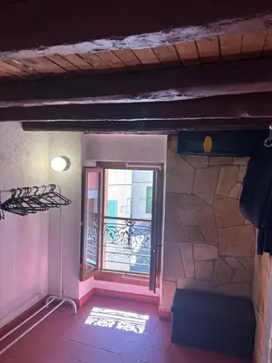 an empty room with a window and a balcony at Morning Coffee & Cobblestones - A True French Village Stay in Villefranche-sur-Mer