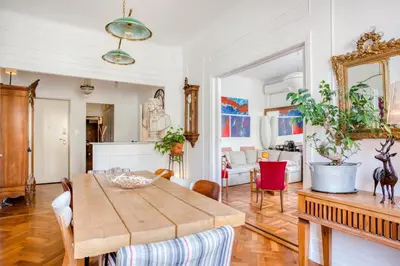 a living room with a wooden table and chairs at Chambre chez l'habitant - Centre Nice 10 min de la plage in Nice