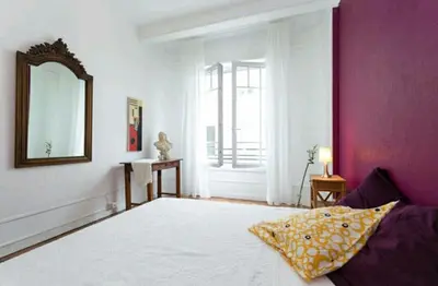 a bedroom with a large bed and a mirror at Chambre chez l'habitant - Centre Nice 10 min de la plage in Nice