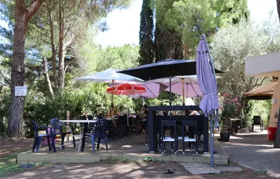 a group of tables and umbrellas in a park at Pleine vue mer au calme - Parking, Piscine, Tennis in Nice