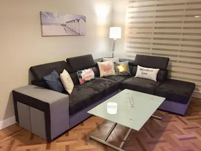 a living room with a couch and a table at 115 Promenade des Anglais in Nice