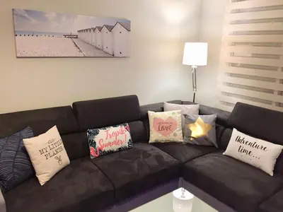 a black couch with pillows on it in a living room at 115 Promenade des Anglais in Nice