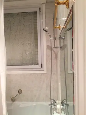 a bathroom with a shower and a sink and a tub at 115 Promenade des Anglais in Nice