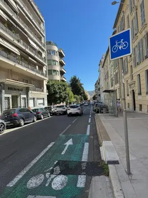 a sign on the side of a street with a bike lane at Large Studio 7 minutes from Beach in Nice