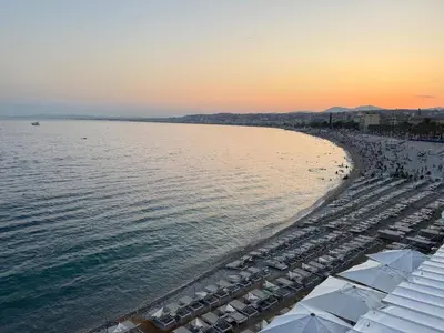 a view of a beach with umbrellas and the ocean at Large Studio 7 minutes from Beach in Nice