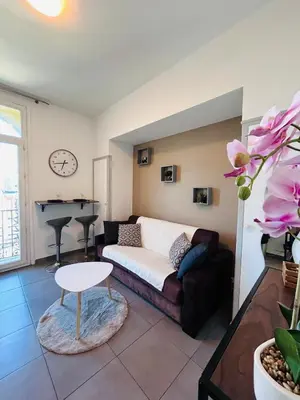a living room with a couch and a table at Studio Rénové et Meublé Le Cœur de Nice à Vos Pieds in Nice