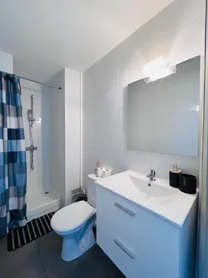 a white bathroom with a toilet and a sink at Studio Rénové et Meublé Le Cœur de Nice à Vos Pieds in Nice