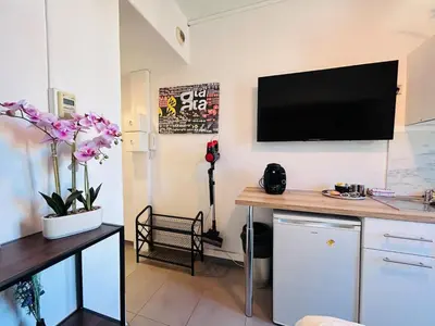 a living room with a television on the wall at Studio Rénové et Meublé Le Cœur de Nice à Vos Pieds in Nice