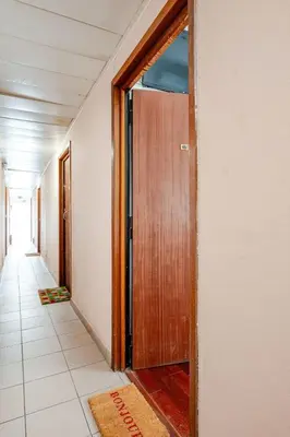 an empty hallway with a wooden door in a room at studette a coté de la mer et la promenade in Nice