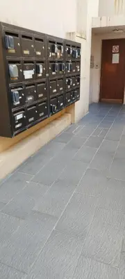 a hallway of a building with lockers and a door at studette a coté de la mer et la promenade in Nice