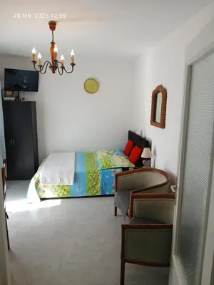 a bedroom with a bed and a chair at Studio Proche mer Nice in Nice