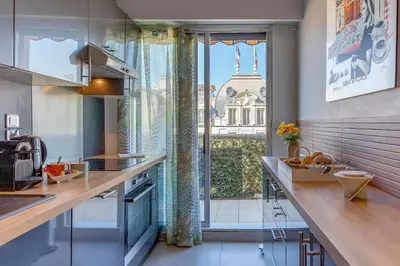 a kitchen with a counter and a large window at FRANCIA AZUR AP4483 by RIVIERA HOLIDAY HOMES in Nice