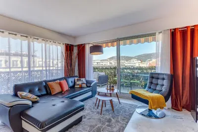 a living room with a blue couch and a large window at FRANCIA AZUR AP4483 by RIVIERA HOLIDAY HOMES in Nice