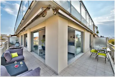a patio with a couch and a table on a building at FRANCIA AZUR AP4483 by RIVIERA HOLIDAY HOMES in Nice