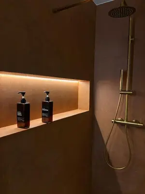 a bathroom with two soap bottles on a shelf at Suite orientale avec baignoire balnéo in Cagnes-sur-Mer