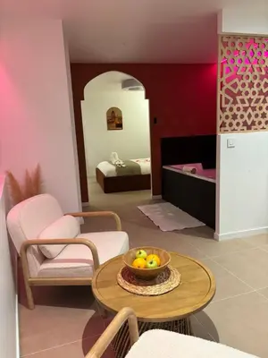 a living room with a bowl of fruit on a table at Suite orientale avec baignoire balnéo in Cagnes-sur-Mer